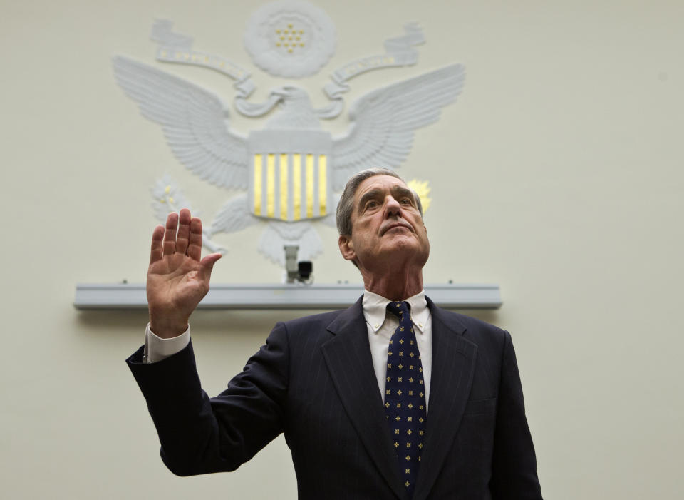 FILE - In this June 13, 2013 file photo, FBI Director Robert Mueller is sworn in on Capitol Hill in Washington prior to testifying before the House Judiciary Committee as it holds an oversight hearing on the FBI. On Friday, Feb. 15, 2018, The Associated Press has found that stories circulating on the internet that the special counsel’s father was Heinrich Mueller, head of the Gestapo under Hitler, are untrue. (AP Photo/J. Scott Applewhite)