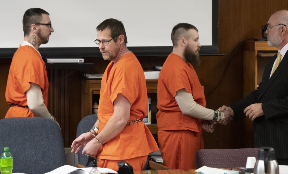 Paul Bellar, left, Pete Musico and Jospeh Morrison appear for sentencing in front of Jackson County Circuit Court Judge Thomas Wilson on Thursday, Dec. 15, 2022 in Jackson, Mich. Paul Bellar, Joseph Morrison and Pete Musico were accused of being involved in a plot to kidnap Michigan Gov. Gretchen Whitmer. The judge on Thursday handed down the longest prison terms so far in the plot to kidnap Michigan's governor, sentencing three men who forged an early alliance with a leader of the scheme before the FBI broke it up in 2020. ( J. Scott Park/Jackson Citizen Patriot via AP)