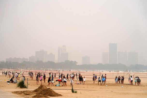 PHOTO: Children participate in a summer camp on Montrose Beach as buildings behind the shore are blanketed in haze from Canadian wildfires, June 27, 2023, in Chicago. (Kiichiro Sato/AP)