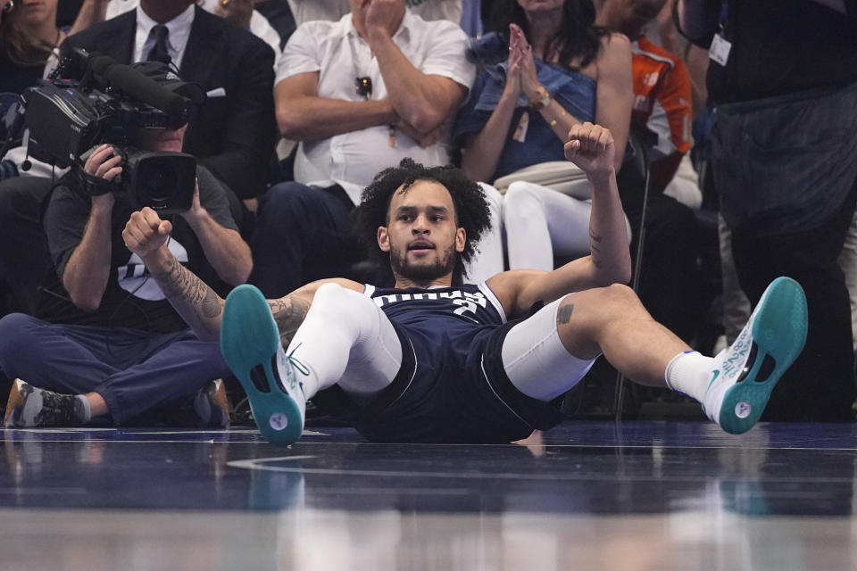 Derek Lively II left the first half of Sunday's playoff game between the Mavericks and Timberwolves after taking a knee to the back of the head.  (AP Photo/Julio Cortez)