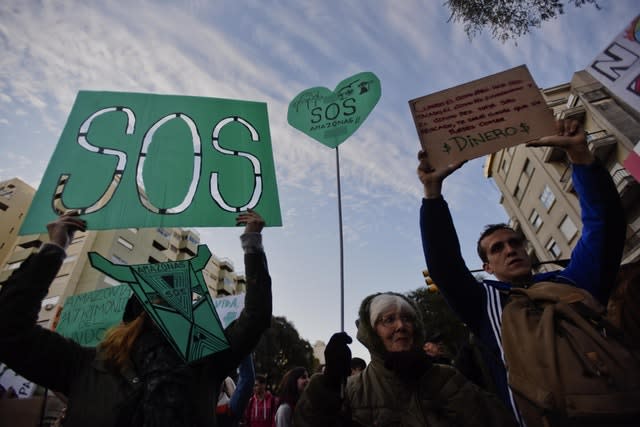 Demonstrators block a road outside the Brazilian embassy in Uruguay