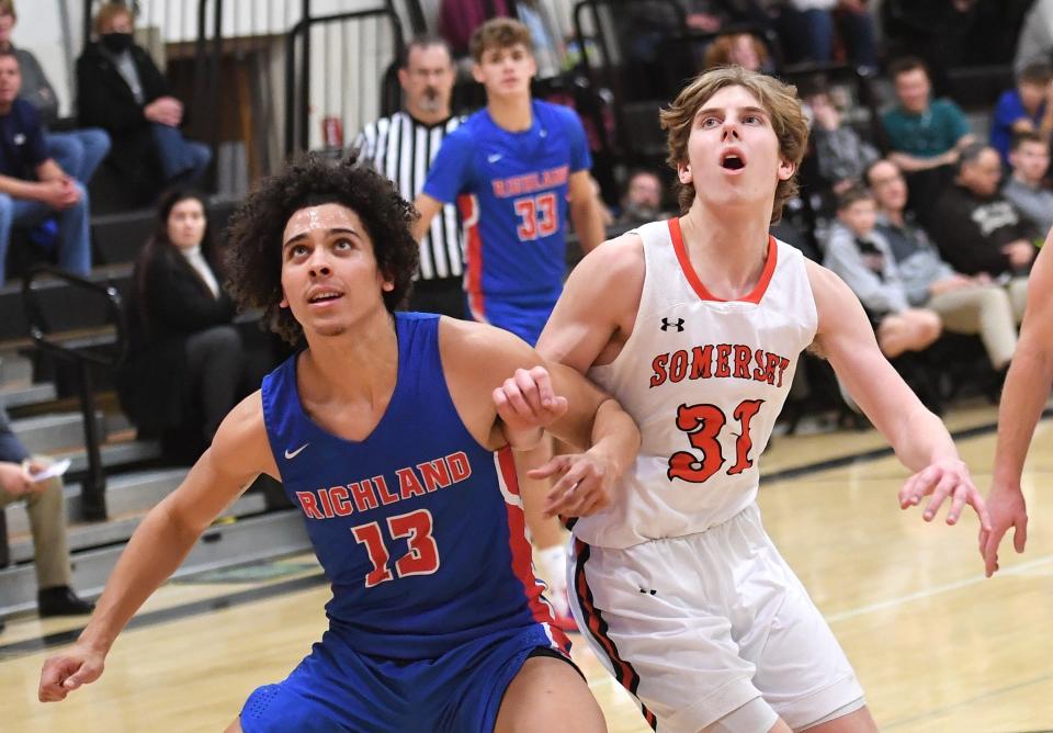 Richland's Griffin LaRue (13) battles for rebounding position with Somerset's Caleb Platt (31) during an LHAC boys basketball contest, Monday, in Somerset.