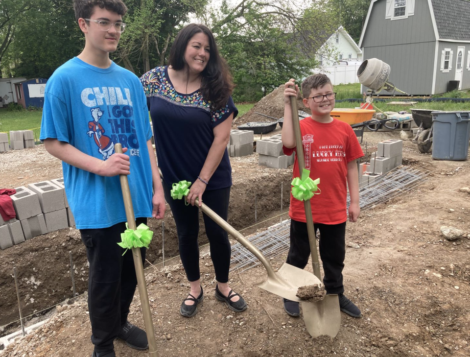 Jenny Koszarek, of Bensalem, and her two boys celebrate the ground breaking for their new home courtesy of Habitat for Humanity.