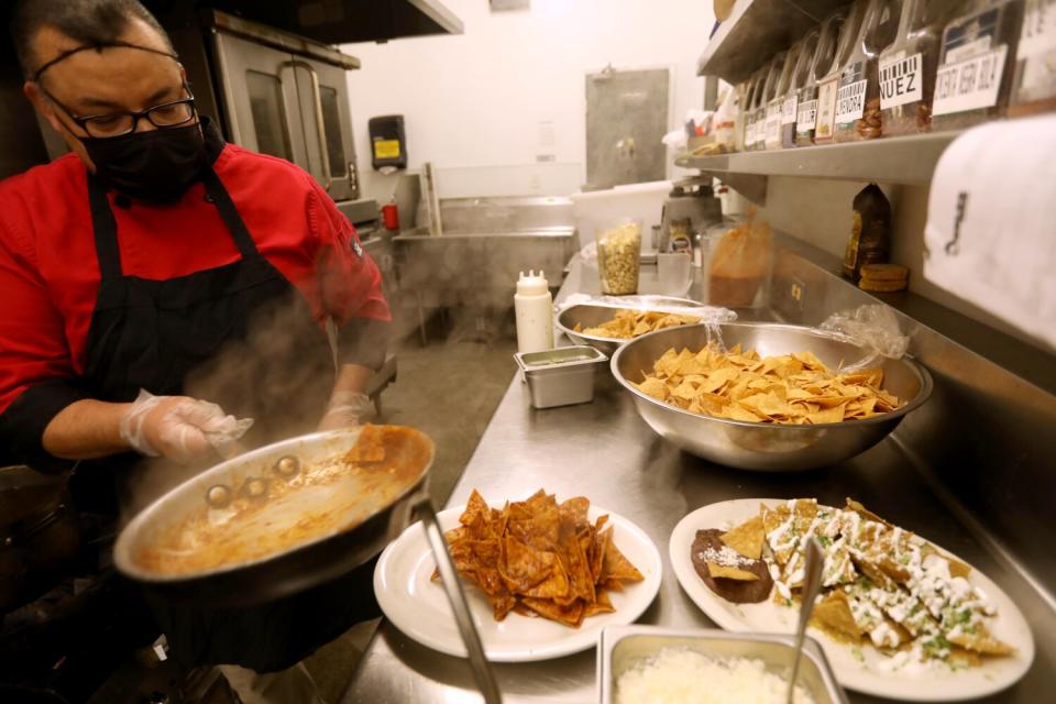 Chef Raul Cruz makes chilaquiles at Loteria Grill in Los Angeles on December 10, 2021.