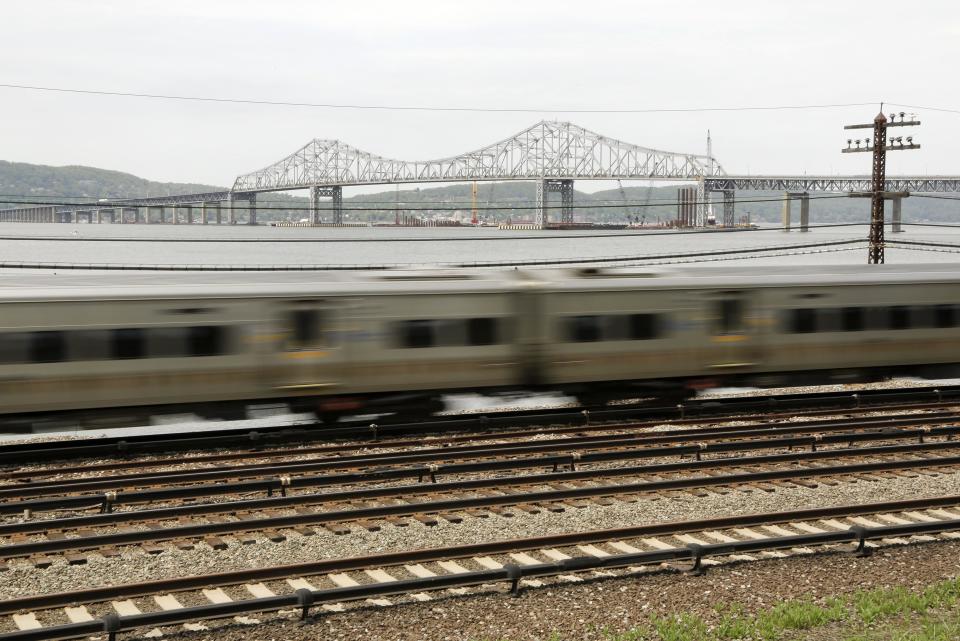 A Metro North train streaks along the Hudson River just south of the Tappan Zee Bridge, Tuesday, May 13, 2014, in Tarrytown, N.Y. On Wednesday, President Barack Obama plans to speak by the bridge just north of New York City to press his case that a key federal government fund used to pay for the nation's roads, bridges and ports is running dry and that the economy would be damaged if it is not replenished. (AP Photo/Julie Jacobson)
