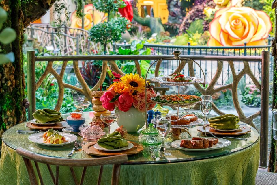 a garden table at sadelles in las vegas with a heavenly brunch spread like bagels and champagne and pastries and more