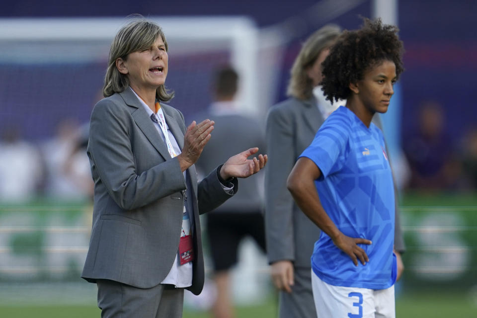 FILE - Italy's manager Milena Bertolini claps her hands next to Italy's Sara Gama, right, during warmup before the Women Euro 2022 group D soccer match between Italy and Belgium at the Manchester City Academy Stadium, in Manchester, England, on July 18, 2022. Longtime captain Sara Gama was left off Italy’s squad for the Women’s World Cup purely “for technical-tactical and physical” reasons, coach Milena Bertolini said Monday. Gama was a surprising omission when Bertolini announced a preliminary 32-woman team for the July 20-Aug. 20 tournament in Australia and New Zealand. (AP Photo/Jon Super, File)