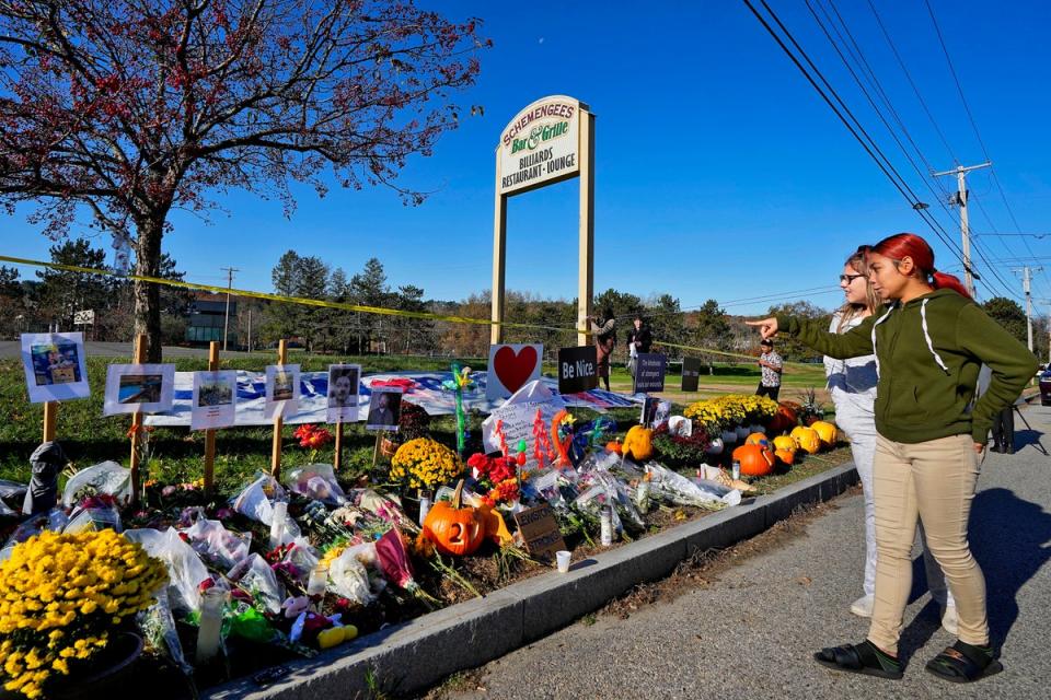 Community members look at a memorial outside Schemengees Bar & Grille about one week after a mass shooting in Lewiston, Maine (Copyright 2023 The Associated Press. All rights reserved)