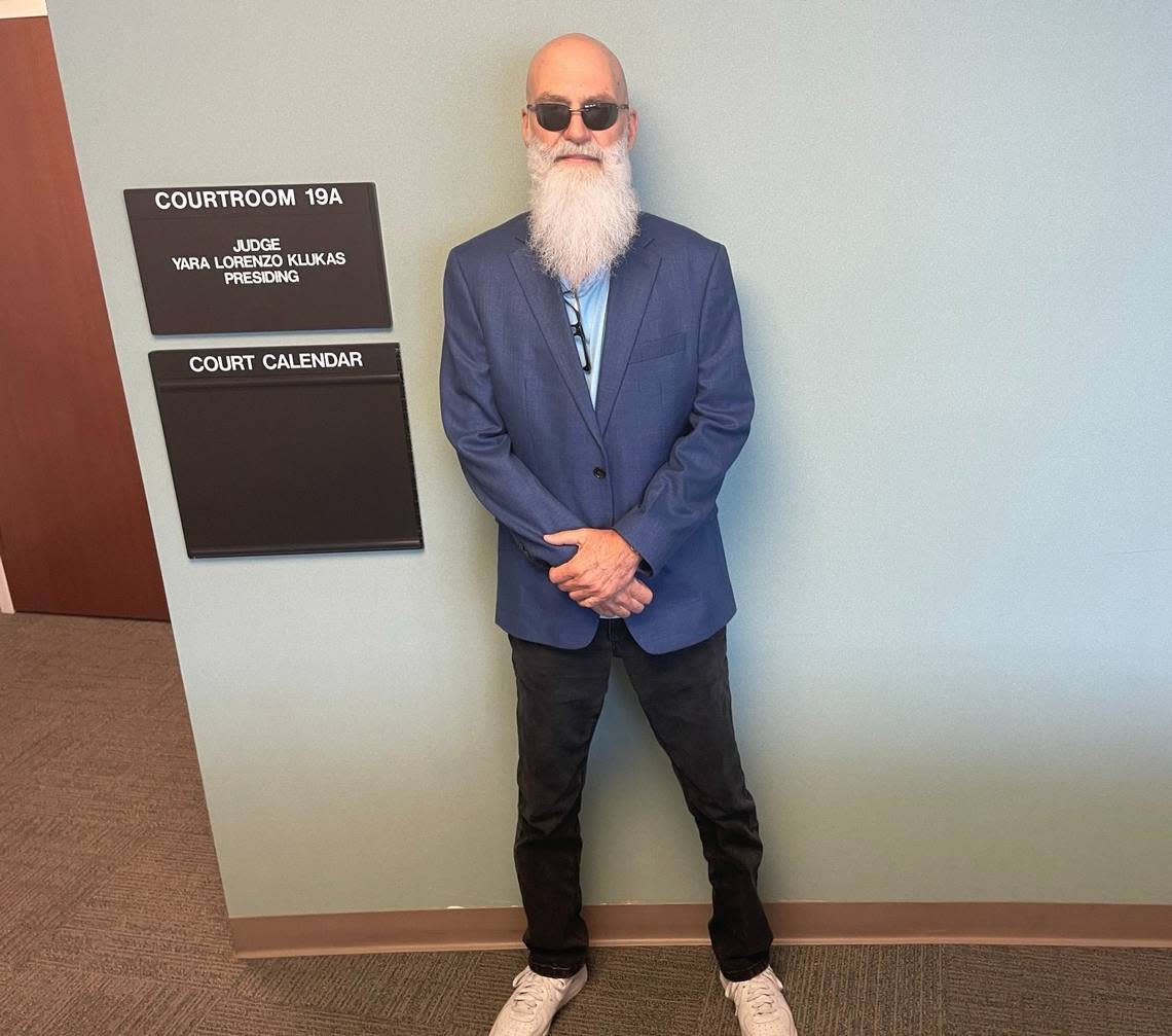 Joe Carrillo, the plaintiff in a stalking complaint against Miami-Dade mayoral candidate Alexander Otaola, poses for a photograph outside the Miami-Dade County courtroom before the proceedings began on April 26, 2024. The judge dismissed Carrillo’s case against Otaola.