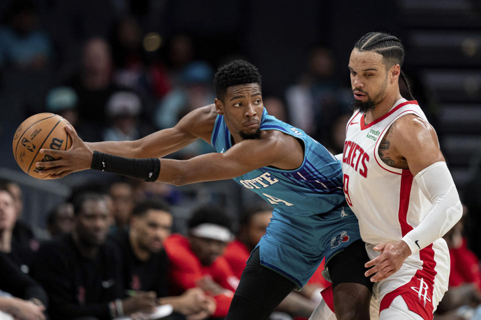 Houston Rockets forward Dillon Brooks (9) guards Charlotte Hornets forward Brandon Miller during the first half of an NBA basketball game Friday, Jan. 26, 2024 in Charlotte, N.C. (AP Photo/Jacob Kupferman)