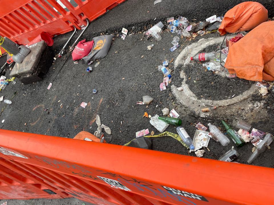 A sidewalk on Las Vegas Boulevard that is covered in trash.