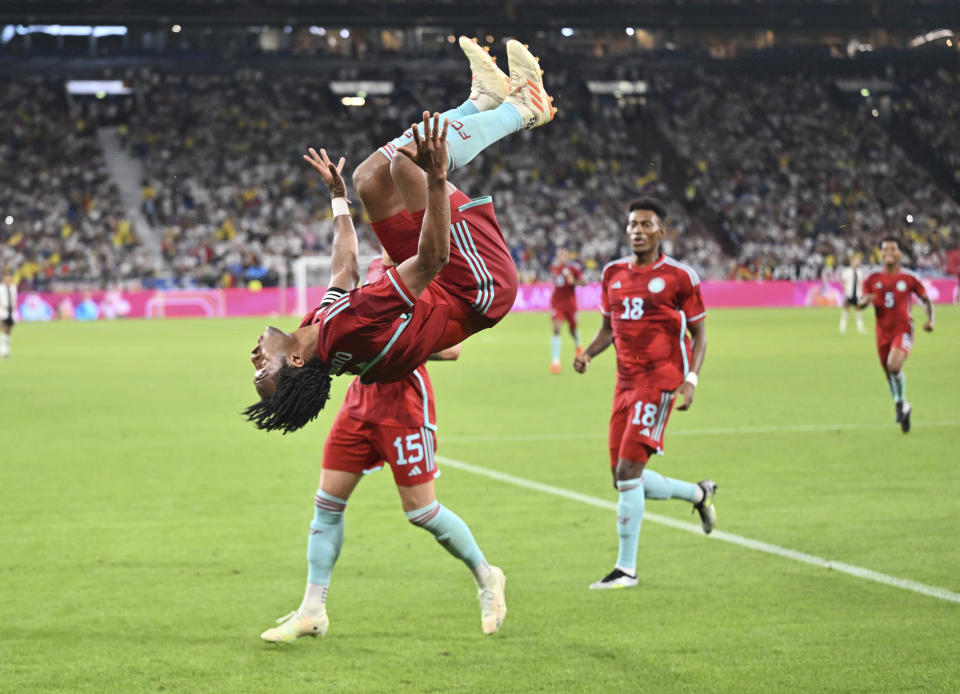 Colombia's Juan Cuadrado does a somersault after his penalty kick goal during an international friendly soccer match between Germany and Colombia at Veltins-Arena in Gelsenkirchen, Germany, Tuesday, June 20, 2023. (Bernd Thissen/dpa via AP)