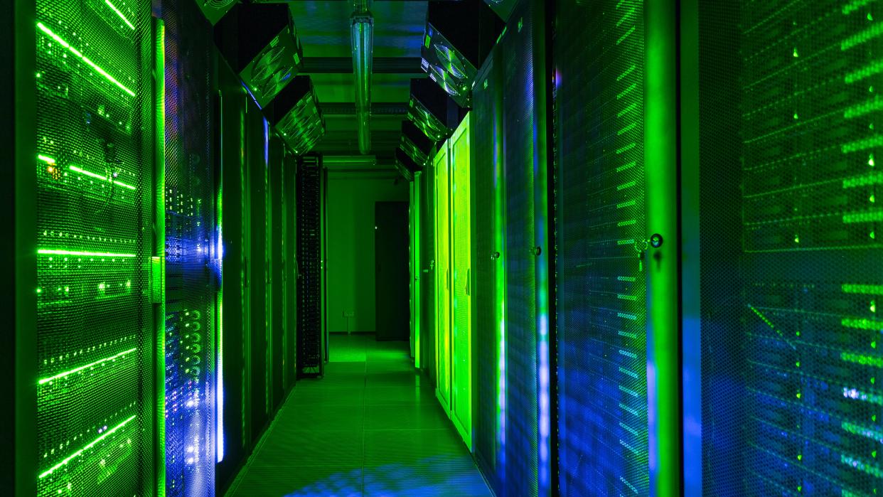  Data center server room lit with green lights. 