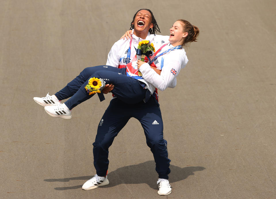 <p>Silver medalist Kye Whyte and gold medalist Bethany Shriever of Great Britain pose for a photograph while celebrating at the medal ceremony after the July 30 women's BMX final.</p>