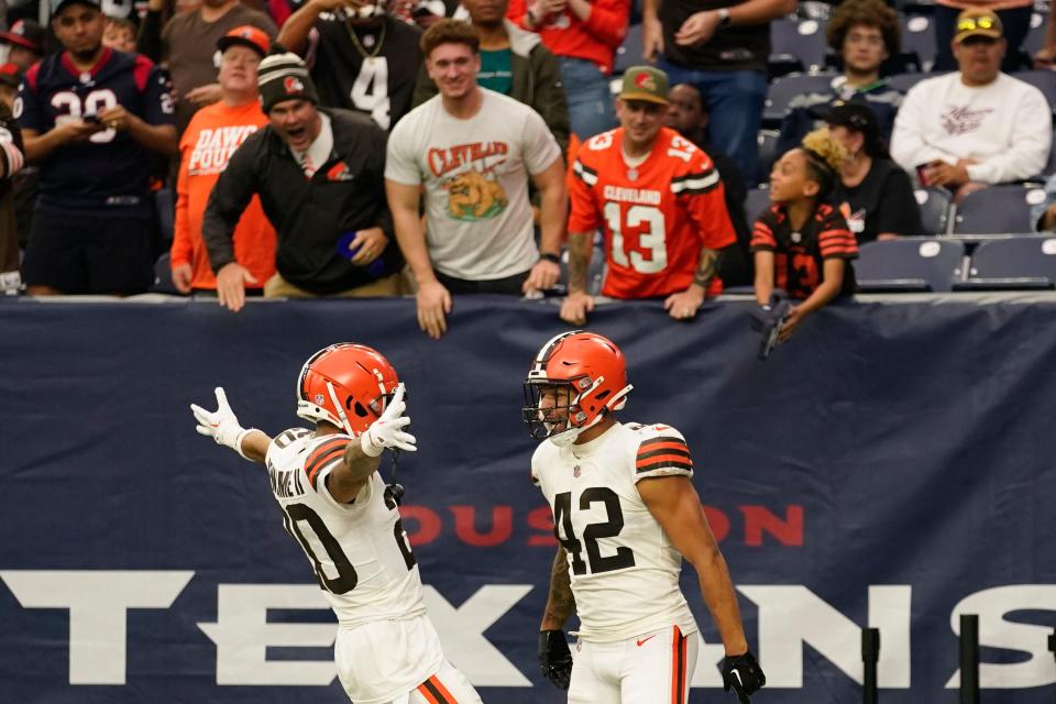 Cleveland Browns linebacker Tony Fields II (42) celebrates with Greg Newsome II after scoring on an interception from Houston Texans quarterback Kyle Allen during the second half of an NFL football game between the Cleveland Browns and Houston Texans in Houston, Sunday, Dec. 4, 2022. (AP Photo/Eric Christian Smith)