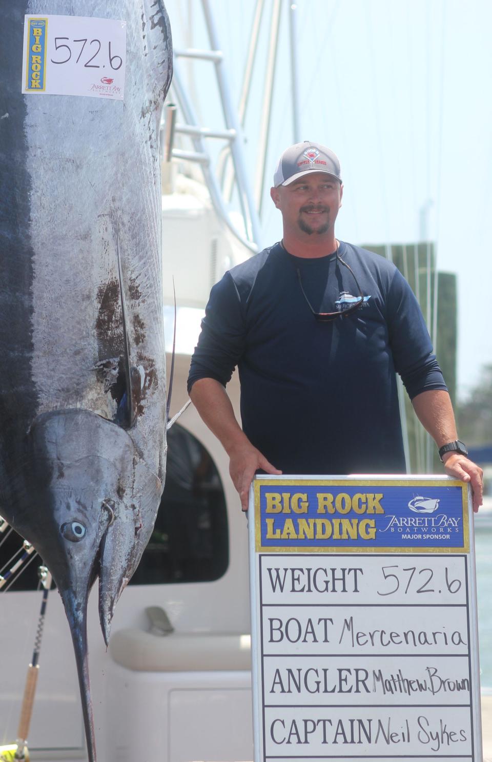 Mercenaria angler Matthew Brown stands next to the 572.6-pound catch that earned the crew the Level V Fabulous Fisherman's prize of $777,750 from the Big Rock's $5,856,750 purse.
