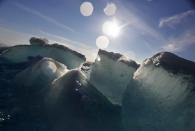 FILE - Broken blocks of sea ice emerge from under the hull of the Finnish icebreaker MSV Nordica as it sails through the Victoria Strait while traversing the Arctic's Northwest Passage, Friday, July 21, 2017. The Arctic is warming three times faster than the rest of the planet and is on such a knife’s edge of survival that the 2021 U.N. climate negotiations in Scotland could make the difference between ice and water at the top of the world in the same way that a couple of tenths of a degree matter around the freezing mark, scientists say. (AP Photo/David Goldman, File)