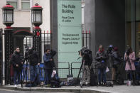 Journalists and TV cameras outside the Royal Courts of Justice, Rolls Building, where Justice Timothy Fancourt gave his ruling in the Prince Harry phone hacking lawsuit in London, Friday, Dec. 15, 2023. Prince Harry has won his phone hacking lawsuit against the publisher of the Daily Mirror and was awarded over 140,000 pounds ($180,000) in the first of his several lawsuits against the tabloids to go to trial. Fancourt found on Friday that phone hacking was "widespread and habitual" at Mirror Group Newspapers over many years. (AP Photo/Kin Cheung)