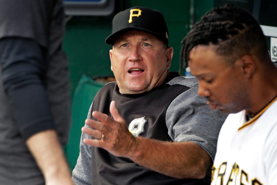 Pittsburgh Pirates acting manager Tom Prince, center, sits in the dugout with first base coach Kimera Bartee, right, before a baseball game against the New York Mets in Pittsburgh, Friday, Aug. 2, 2019. Prince, the team's bench coach, was filling in for manager Clint Hurdle, who was serving a two-game suspension as a result of his involvement in a bench-clearing brawl during a baseball against the Cincinnati Reds earlier that week.