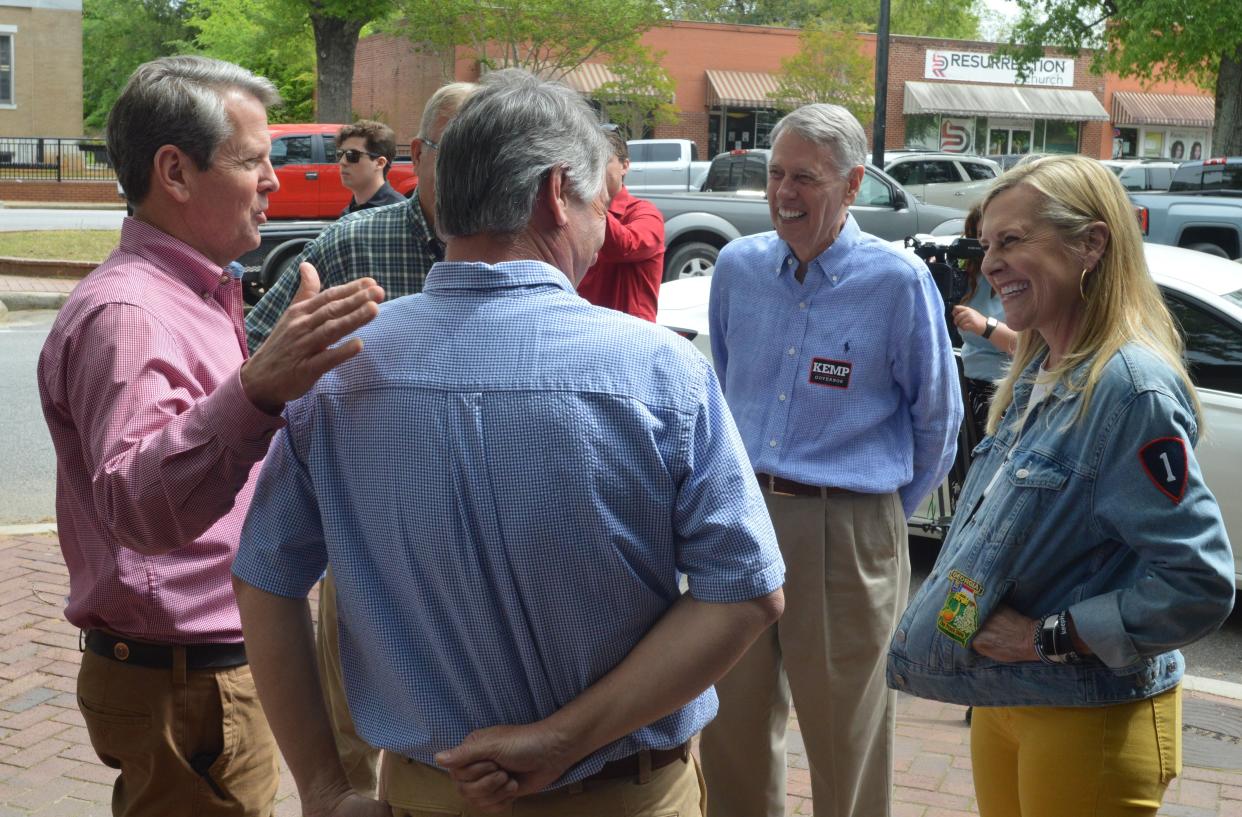 Gov. Brian Kemp (left) and his wife Marty (right) meet with Jefferson County business owners during their stop in Louisville Thursday, April 14.