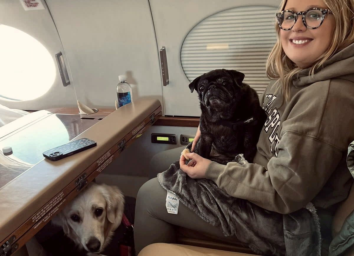 Maddie Young, 31, said it was cheaper to fly her two dogs on a private jet (Maddie Young / SWNS)