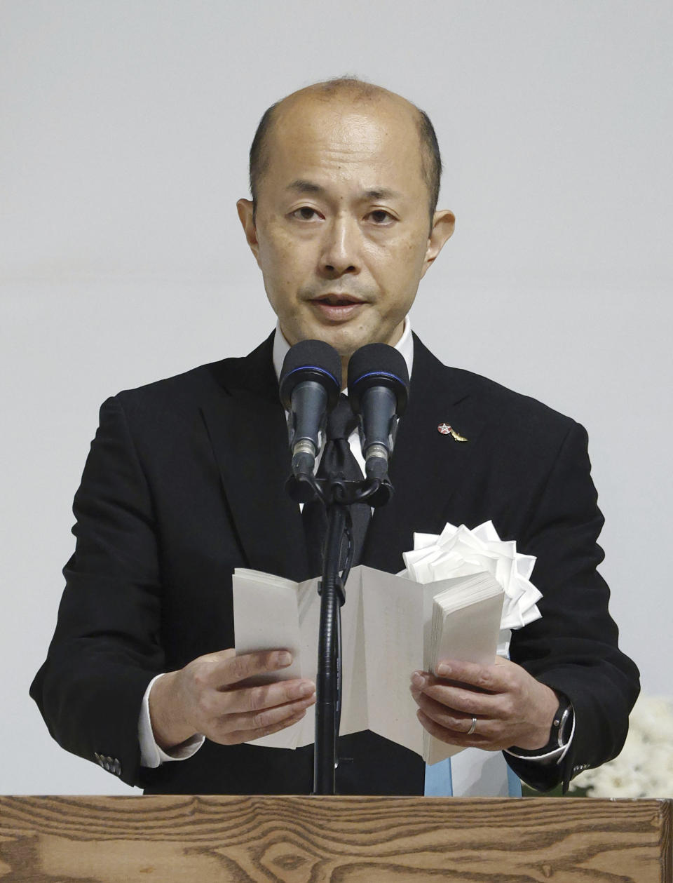 Nagasaki Mayor Shiro Suzuki delivers a speech during a ceremony to mark the 78th anniversary of the atomic bombing in Nagasaki, southern Japan Wednesday, Aug. 9, 2023. The ceremony was held indoors and scaled down due to approaching Tropical Storm Khanun. (Kyodo News via AP)