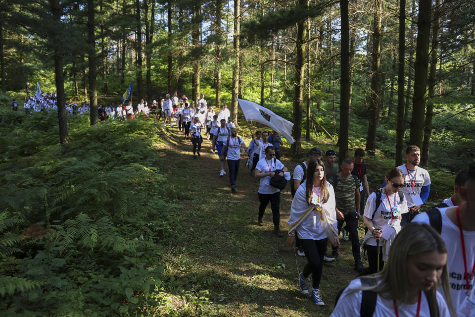 Participants in the "March of Peace", march in memory of the 1995 Srebrenica massacre, in Nezuk, Bosnia, Saturday, July 8, 2023. A solemn peace march started on Saturday through forests in eastern Bosnia in memory of the 1995 Srebrenica massacre, Europe's only acknowledged genocide since World War II. The 100-kilometre (60-mile) march traces a route taken by Bosniak men and boys as they tried to flee Srebrenica after it was captured by Bosnian Serb forces in the closing days of the country's interethnic war in the 1990s. (AP Photo/Armin Durgut)