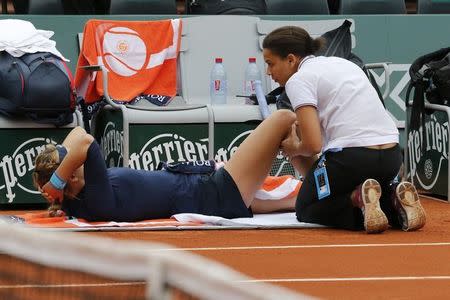 Tennis - French Open - Roland Garros - Karin Knapp of Italy vs Victoria Azarenka of Belarus - Paris, France - 24/05/16. Victoria Azarenka gets medical help. REUTERS/Pascal Rossignol