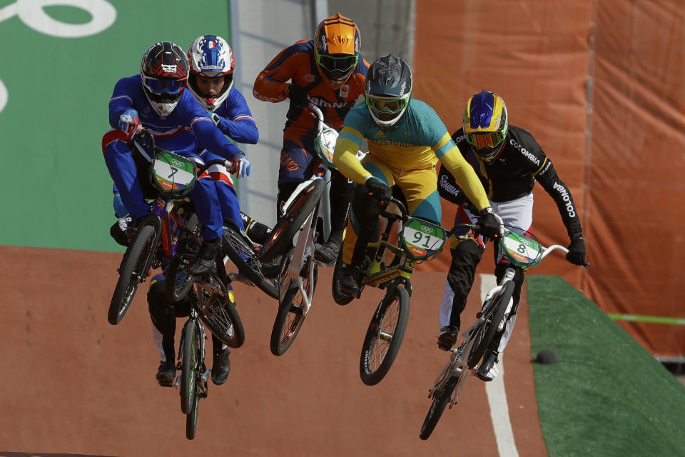 FILE - Cyclists, front from right, Carlos Ramirez Yepes, of Colombia, Sam Willoughby, of Australia, and Amidou Mir, of France, compete in the BMX cycling quarterfinals during the 2016 Summer Olympics in Rio de Janeiro, Brazil, Thursday, Aug. 18, 2016. In the background left is Kyle Evans of Britain. Sam Willoughby made a mistake during practice, doing something he did every day for 10 years prior, and broke his back. (AP Photo/John Locher, File)