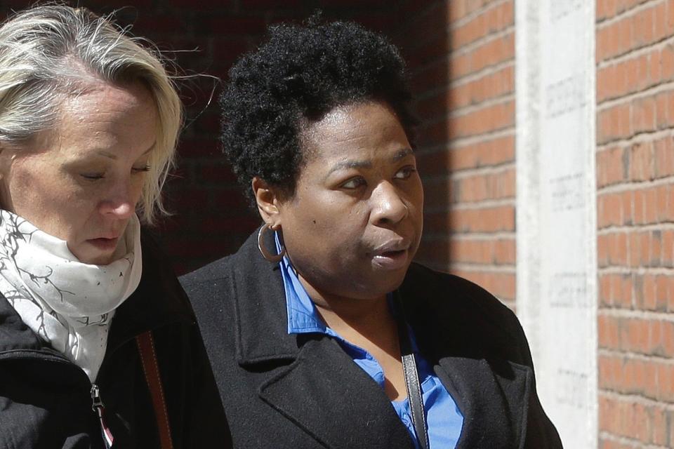 In this March 25, 2019, file photo, former college entrance exam administrator Niki Williams of Houston, right, arrives at federal court in Boston to face charges in a nationwide college admissions bribery scandal.