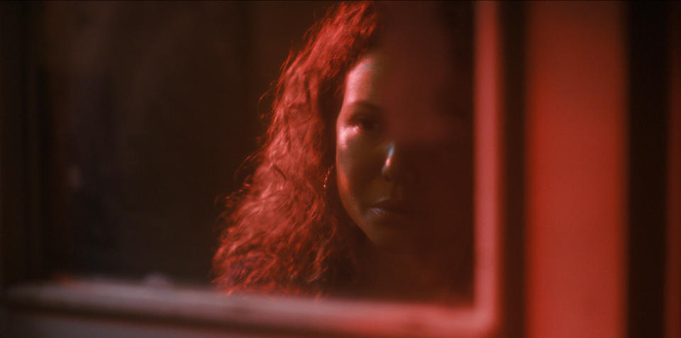 Dolores Roach (Justina Machado) contemplates her reflection in the mirror.<span class="copyright">Courtesy of Prime Video</span>