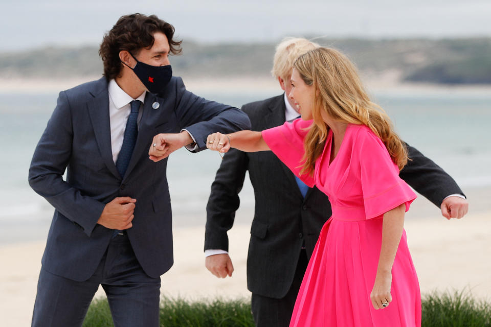 Canada's Prime Minister Justin Trudeau (L) meets Britain's Prime Minister Boris Johnson (C) and his wife Carrie Johnson (R) as he arrives for the G7 summit in Carbis Bay, Cornwall, south-west England on June 11, 2021. (Photo by PHIL NOBLE / POOL / AFP) (Photo by PHIL NOBLE/POOL/AFP via Getty Images)