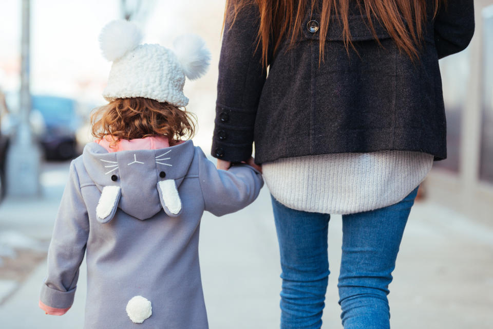 a child being held bytheir mom