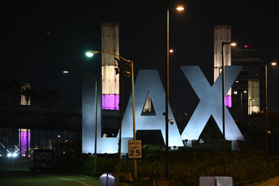 Lights of purple and gold illuminate the pylons outside of LAX in remembrance of former NBA basketball player Kobe Bryant in Los Angeles, Sunday, Jan. 26, 2020, following reports of his death in a helicopter crash in southern California. (AP Photo/Kelvin Kuo)