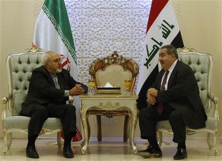 Iran's Foreign Minister Mohammad Javad Zarif meets with his Iraqi counterpart Hoshyar Zebari (R) at the Baghdad airport September 8, 2013. REUTERS/ Saad Shalash