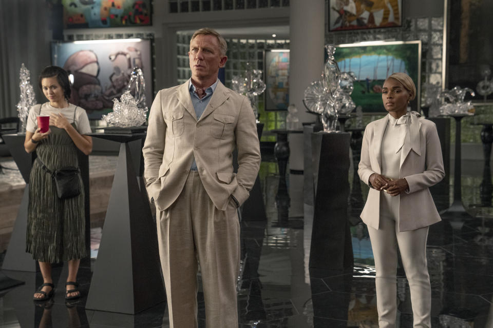 This image released by Netflix shows Jessica Henwick, left, Daniel Craig, center, and Janelle Monáe in a scene from "Glass Onion: A Knives Out Mystery." (John Wilson/Netflix via AP)