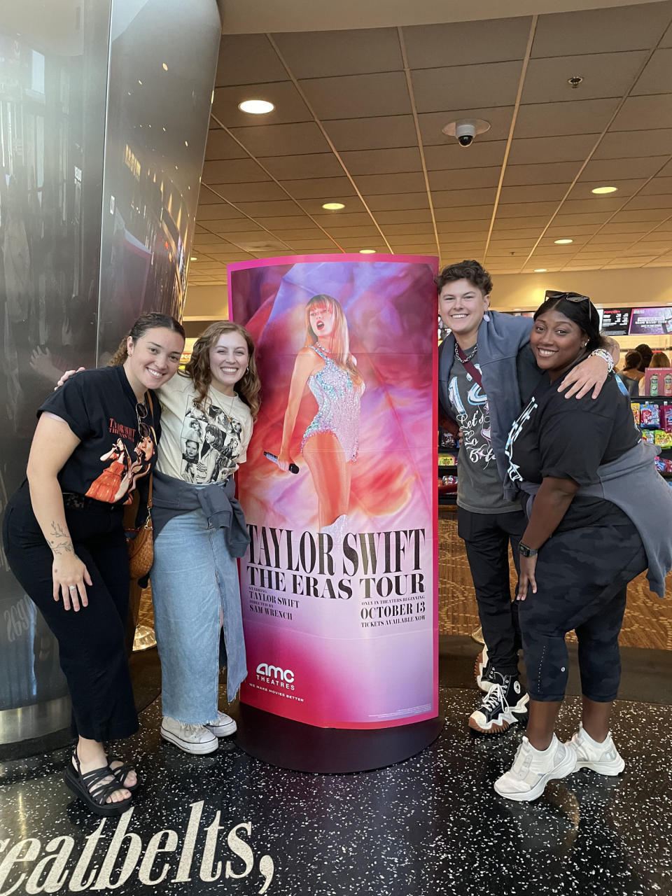 A group of young people pose in front of a Taylor Swift poster (Ariana Brockington / TODAY)