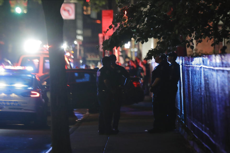 CORRECTS DAY AND DATE - New York City police officers gather early Thursday, June 4, 2020, in the Brooklyn borough of New York. The police department says an officer has been shot in Brooklyn. The shooting happened late Wednesday, nearly four hours after an 8 p.m. curfew went into effect intended to quell unrest over the death of George Floyd in Minnesota. Details on the shooting, including the officer's condition, weren’t immediately available. (AP Photo/Frank Franklin II)