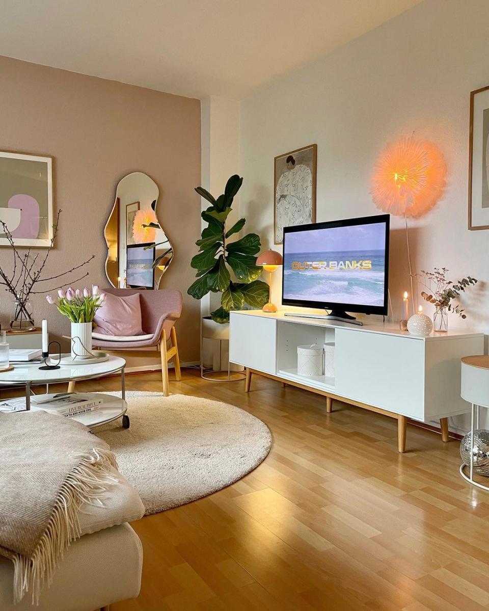 Living room with white rug and TV stand