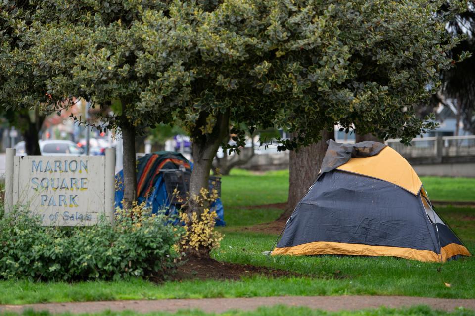 People experiencing homelessness in Marion Square Park on Thursday.
