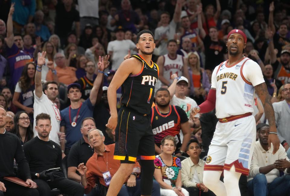 May 5, 2023; Phoenix, AZ, USA; Phoenix Suns guard Devin Booker (1) watches his 3-pointer go in as Denver Nuggets guard Kentavious Caldwell-Pope (5) defends during Game 3 of the Western Conference Semifinals at the Footprint Center. 