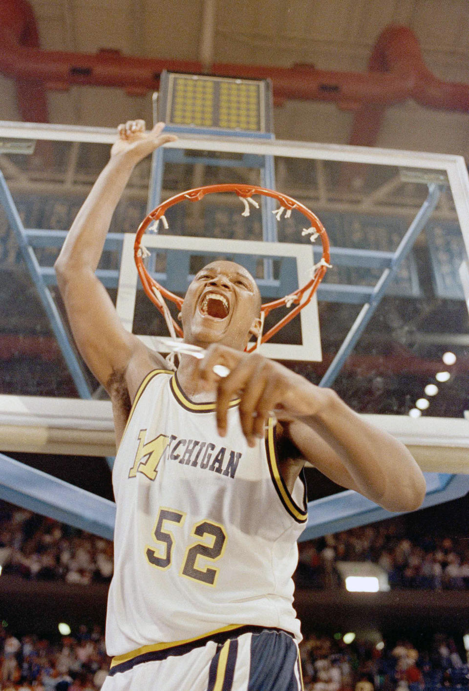 FILE - Michigan's Terry Mills yells and holds up his finger for number one after cutting down the net in Lexington, Ky., March 25, 1989. The Wolverines beat Virginia 102-65 in the NCAA regional to gain a spot in the Final Four at Seattle. (AP Photo/Ed Reinke/File)