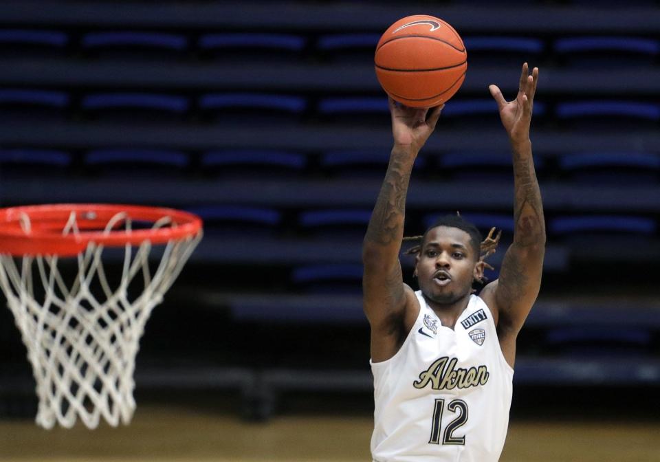 Akron Zips guard Bryan Trimble Jr. shoots a three point shot during the first half of an NCAA basketball game against Malone University at James A. Rhodes Arena, Saturday, Dec. 19, 2020, in Akron, Ohio. [Jeff Lange/Beacon Journal]