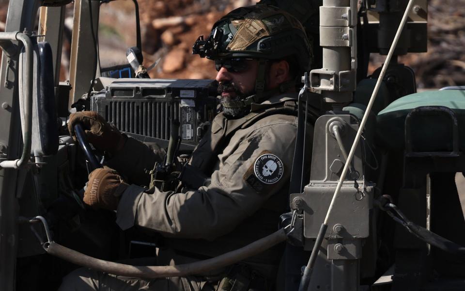 An Israeli soldier sits in a military vehicle at an undisclosed location in northern Israel near the border with Lebanon on Thursday.