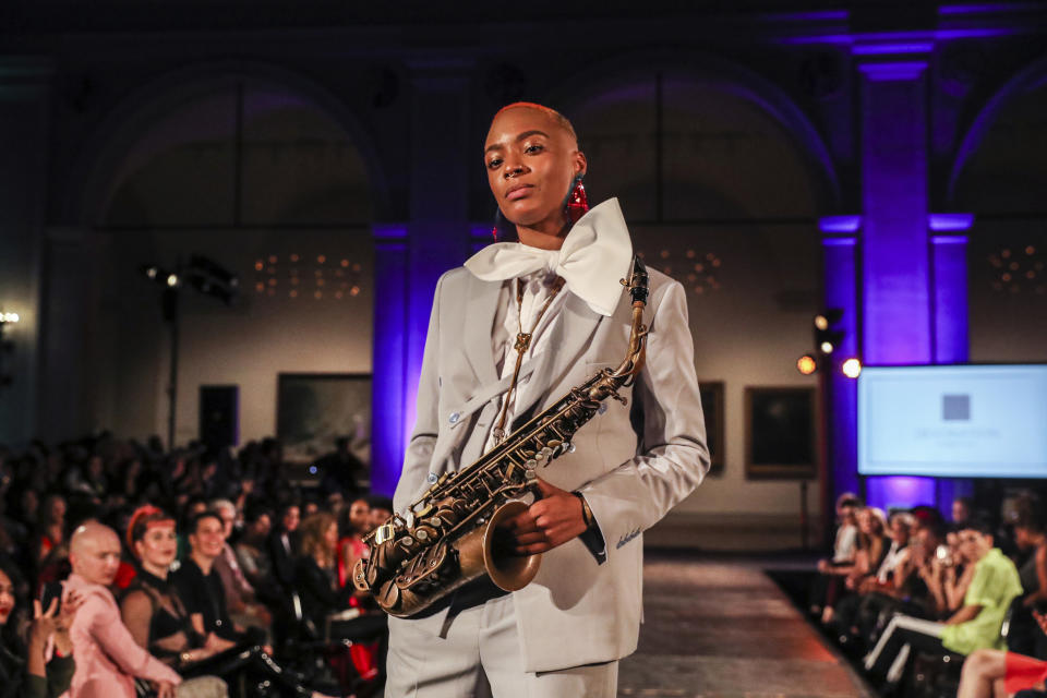 The Devonation by Devon Yan collection is modeled during the dapperQ fashion show at the Brooklyn Museum on Thursday, Sept. 5, 2019, in New York. (AP Photo/Jeenah Moon)