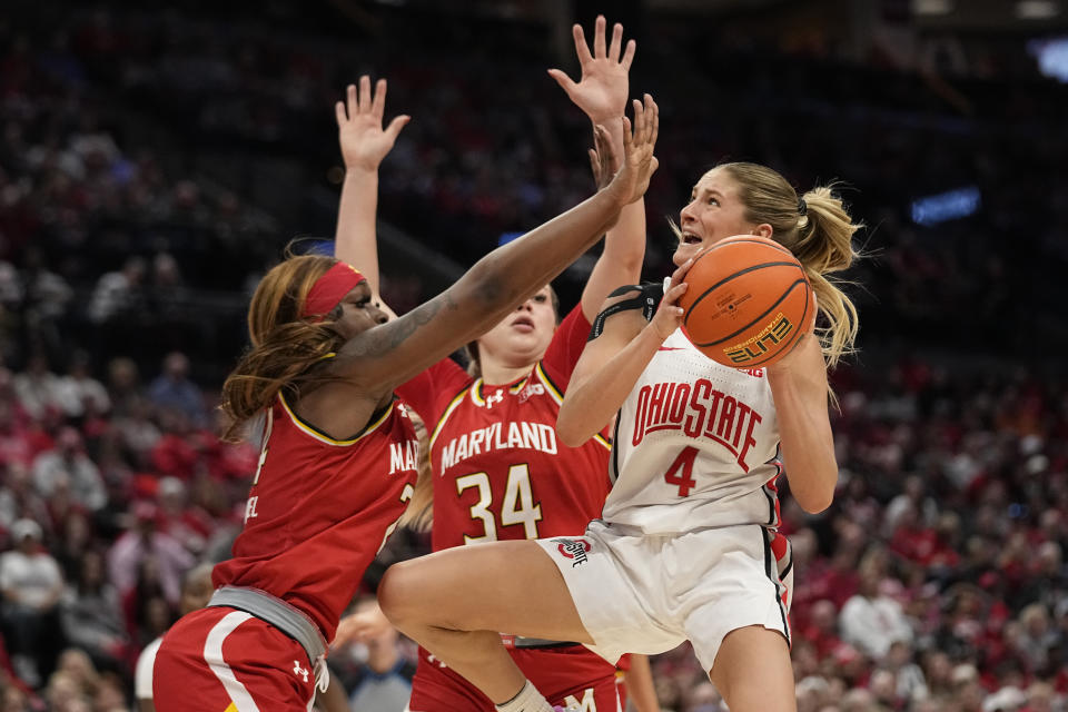 Ohio State guard Jacy Sheldon (4) goes up for a shot in front of Maryland guard Bri McDaniel, left, and guard Emily Fisher (34) in the second half of an NCAA college basketball game Sunday, Feb. 25, 2024, in Columbus, Ohio. (AP Photo/Sue Ogrocki)