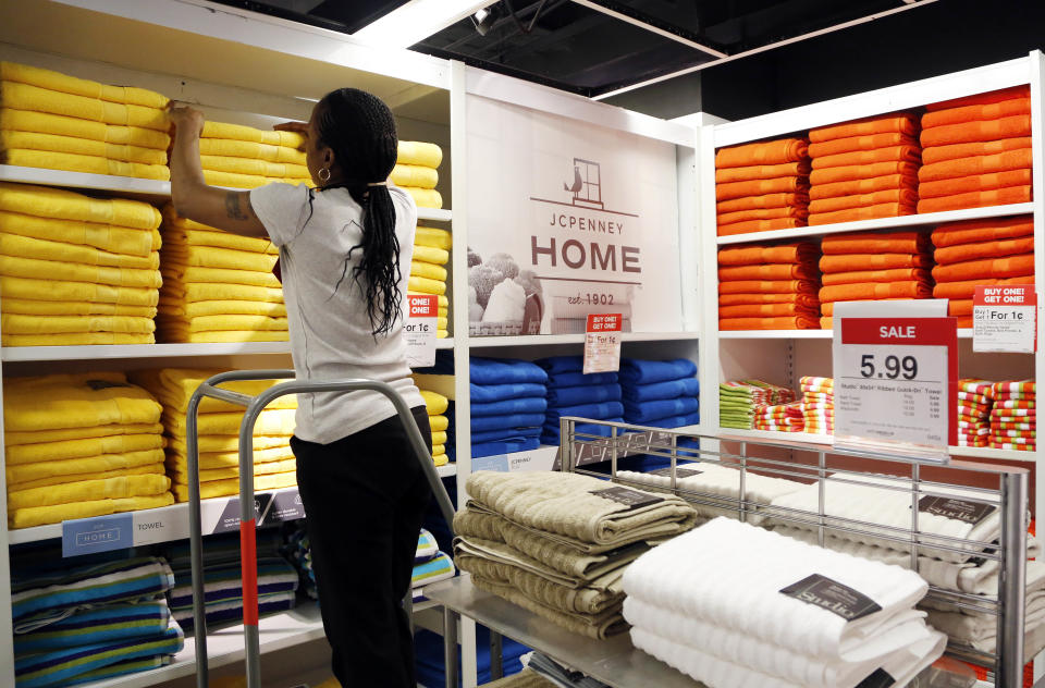 In this March 10, 2016 photo, a sales clerk arranges towels at a J.C. Penney store, in New York. (AP Photo/Mark Lennihan)