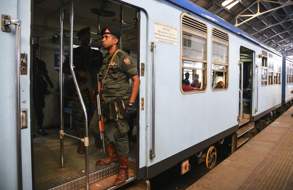 A soldier stands guard in a train during one day strike in Colombo, Sri Lanka, Wednesday, March 15, 2023. Sri Lanka's health, railway, port and other state workers are on a day-long strike Wednesday to protest against sharp increases in income taxes and electricity charges, as the island nation awaits approval of an International Monetary Fund package to aid its bankrupt economy. (AP Photo)