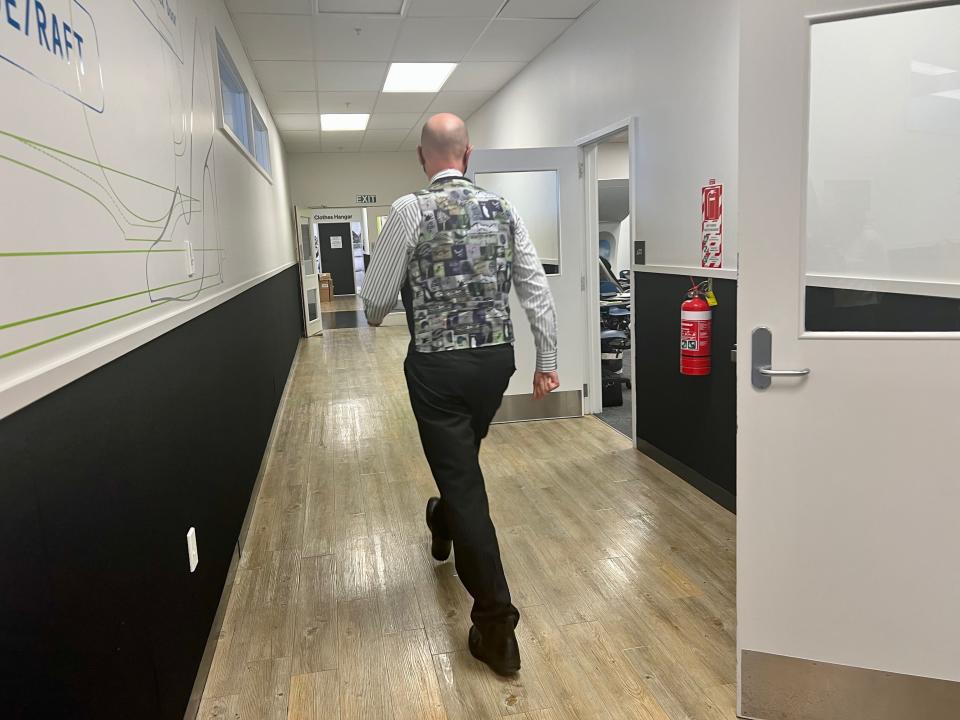 A flight attendant in their uniform walking through the facility — Air New Zealand's Academy of Learning in Auckland.