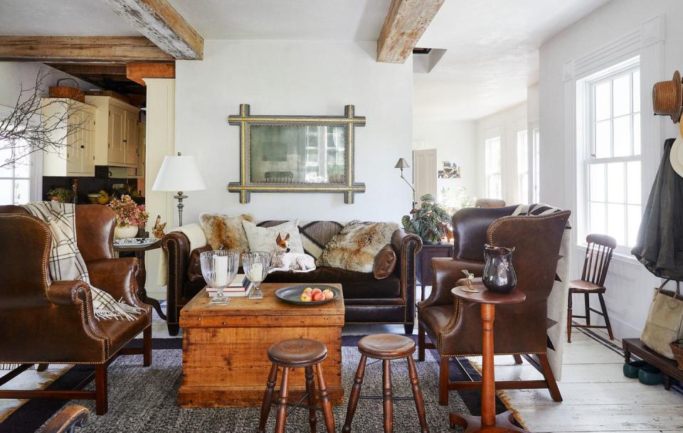 a farmhouse living room with leather furniture